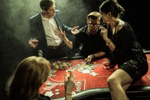 75187929 - group of people playing poker together in casino